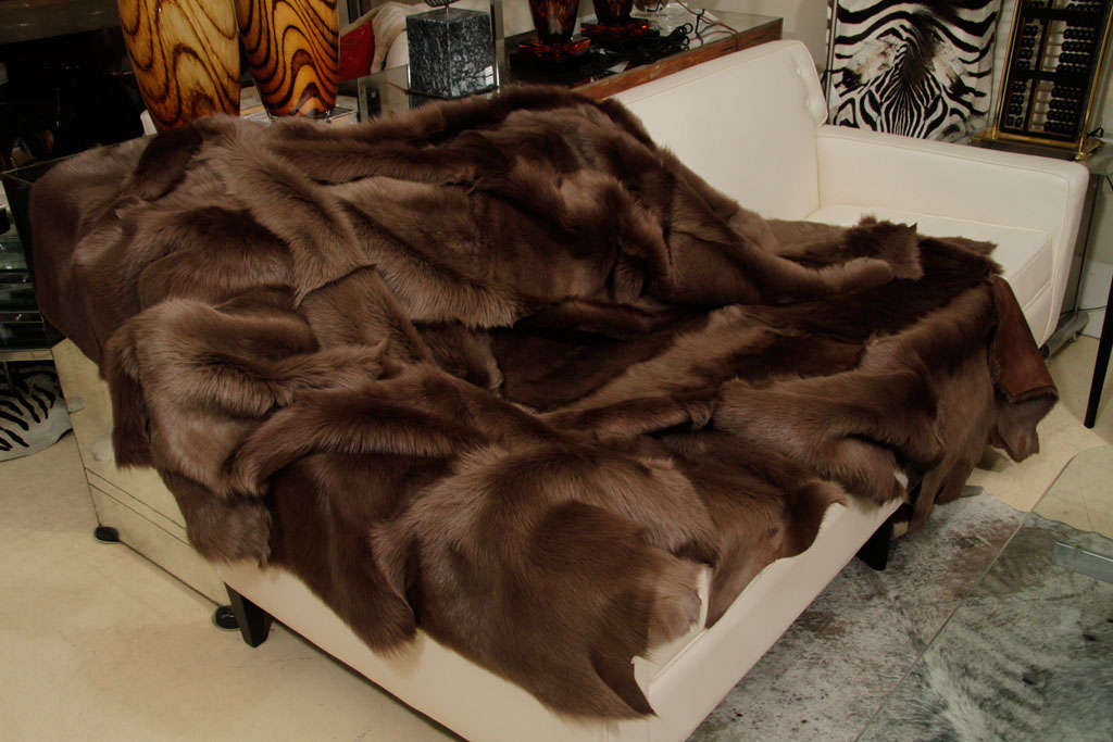 A very beautiful shearling throw in a dusty brown, long hair shearling with the back in napa leather. Raw edges. Delivery time one-two weeks.